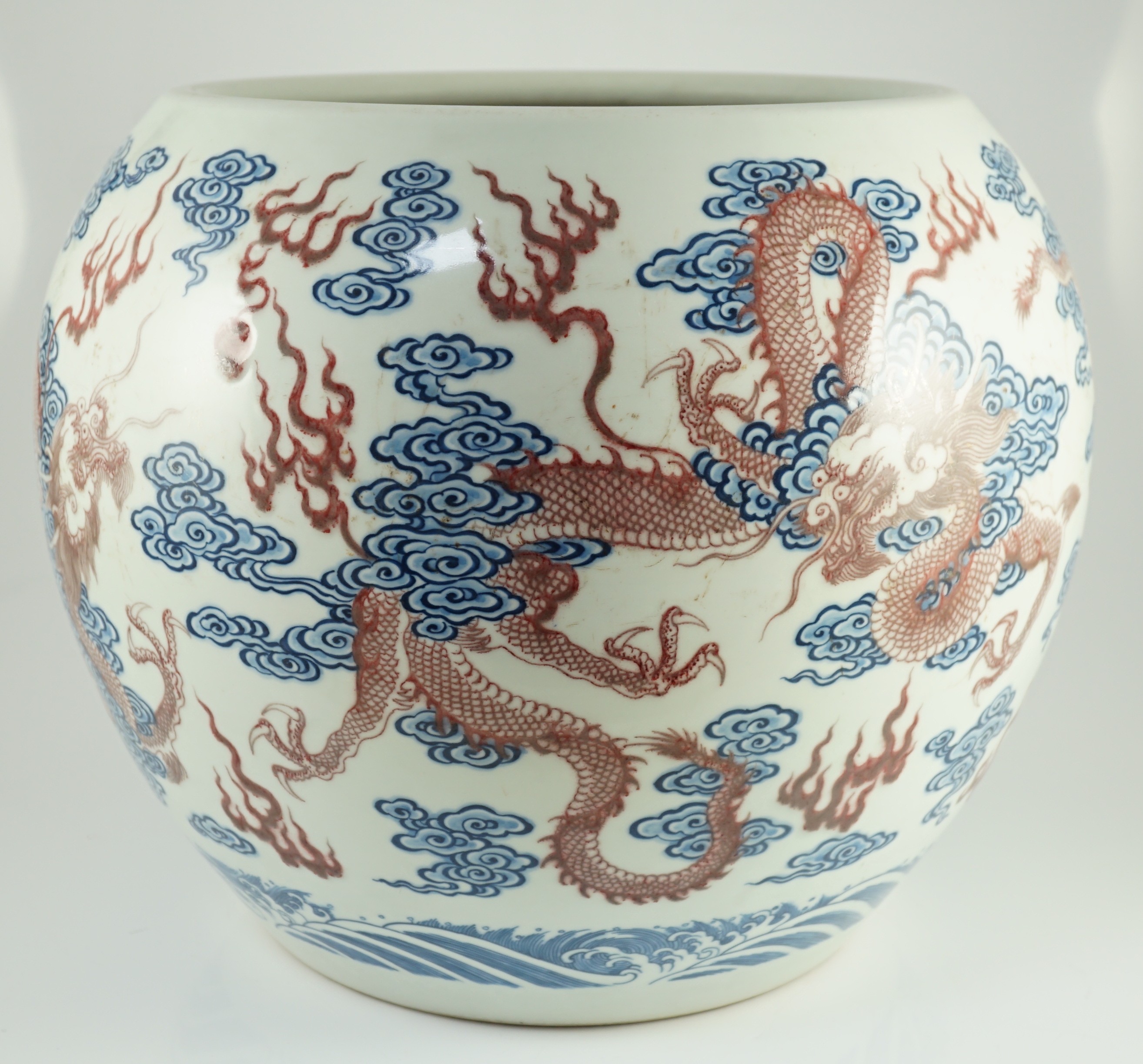 A large Chinese underglaze blue and copper red 'dragon' scroll vessel, 42.5cm diameter, 34.5cm high